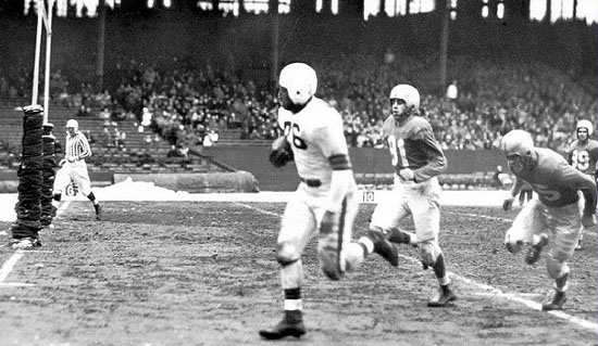 Marion Motley scores one of his three TDs.